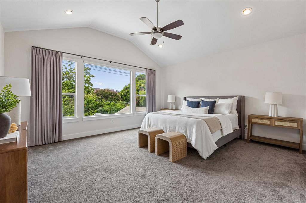 Vaulted ceilings, large triple-pane windows, recessed lighting, and a ceiling fan