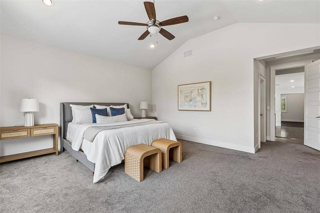 Vaulted ceilings, neutral wall color, recessed lighting, and a dark-finish ceiling fan with integrated lighting