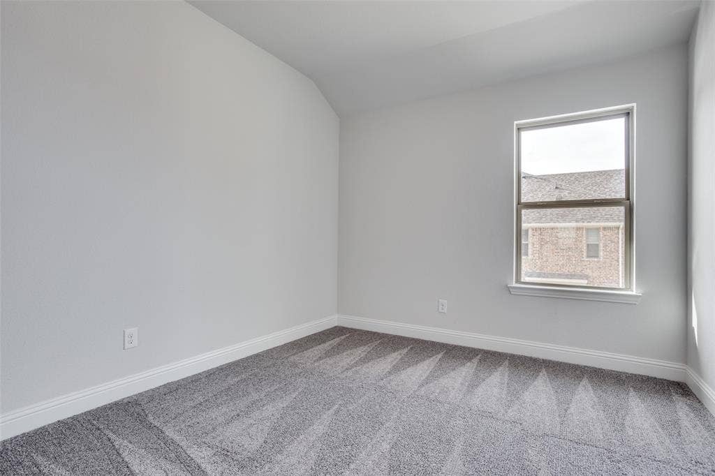 6341 Fortuna Lane, McKinney, TX 75070 Neutral-toned interior room featuring crisp walls, patterned carpeting, and a single-pane window