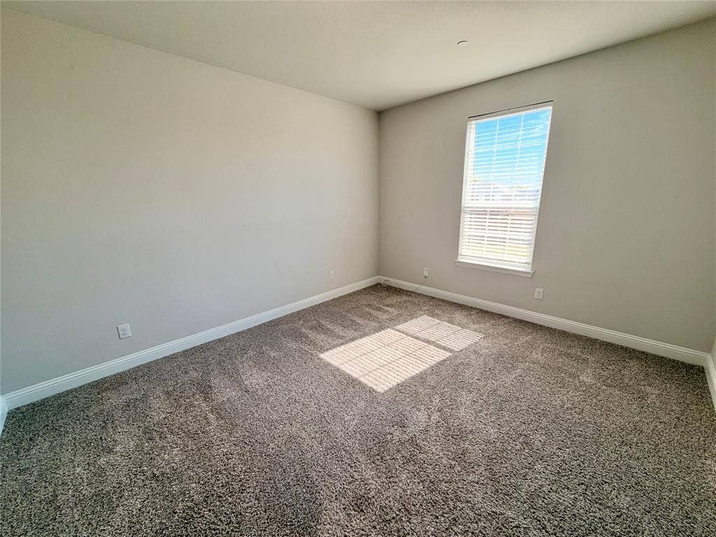 1063 Mj Brown Street, Allen, TX 75002 Neutral wall tones, plush wall-to-wall carpeting, and a single-hung window featuring horizontal blinds