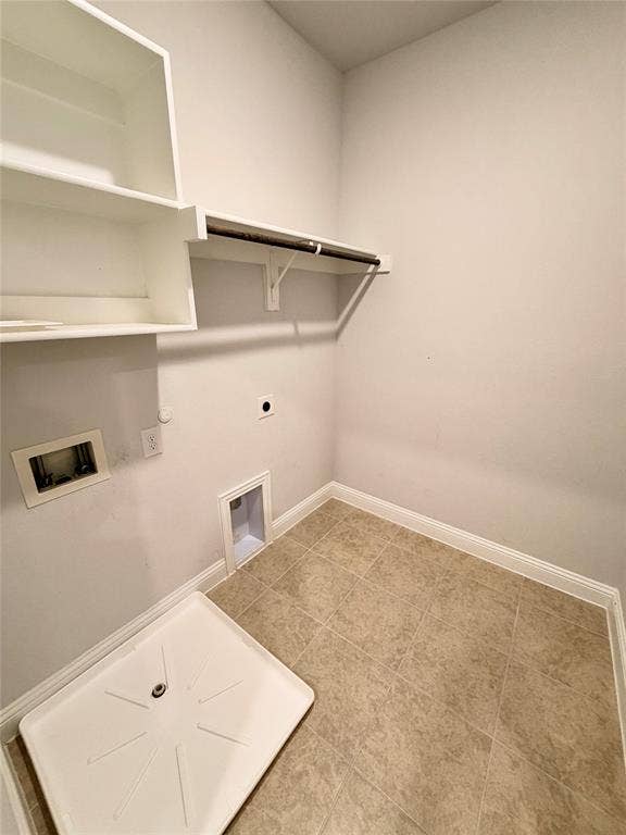 1063 Mj Brown Street, Allen, TX 75002 Utility area featuring ceramic tile flooring, built-in shelving, an integrated hanging rod, and a recessed plumbing connection box with a drain pan