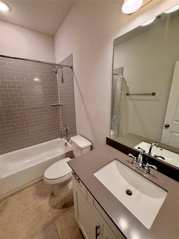 1063 Mj Brown Street, Allen, TX 75002 Bathroom featuring a vanity with a solid-surface countertop and integrated basin, gray subway tile shower surround, polished chrome fixtures, and ceramic tile flooring