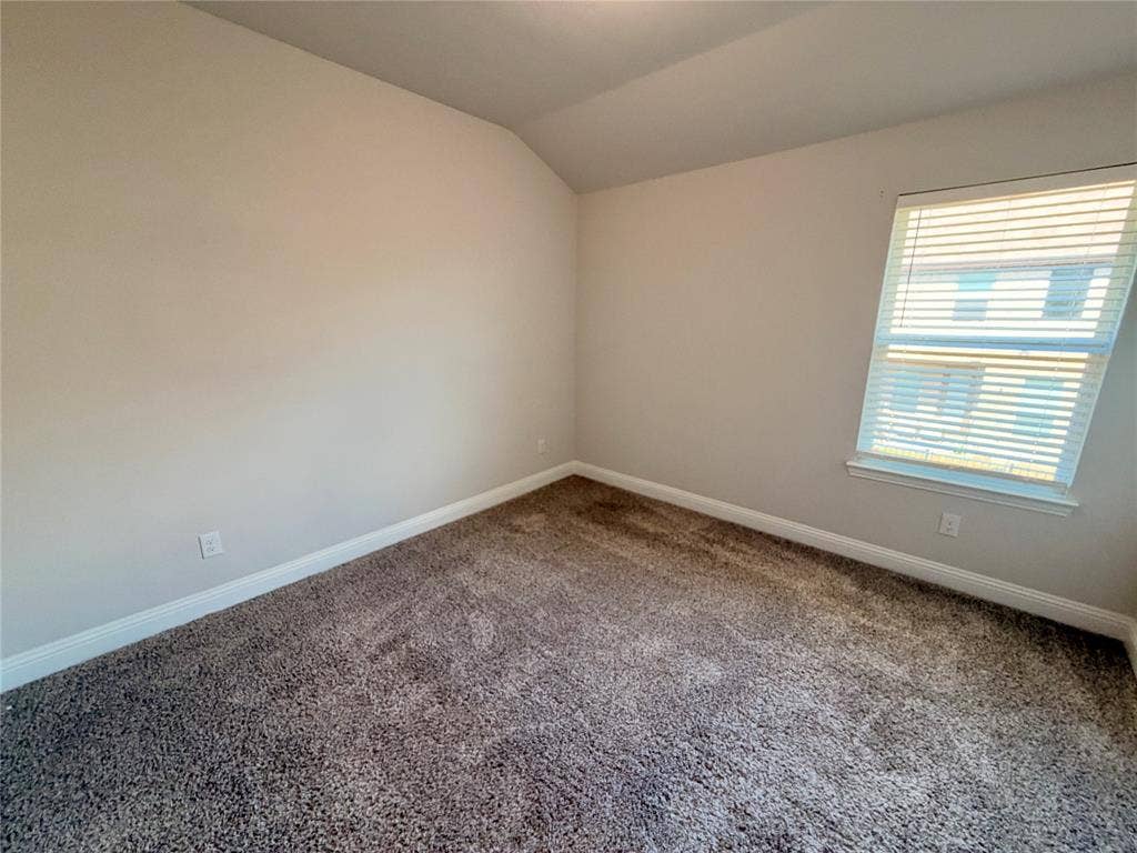 1063 Mj Brown Street, Allen, TX 75002 Room featuring neutral wall paint, vaulted ceiling, carpeting, and a single window with installed blinds