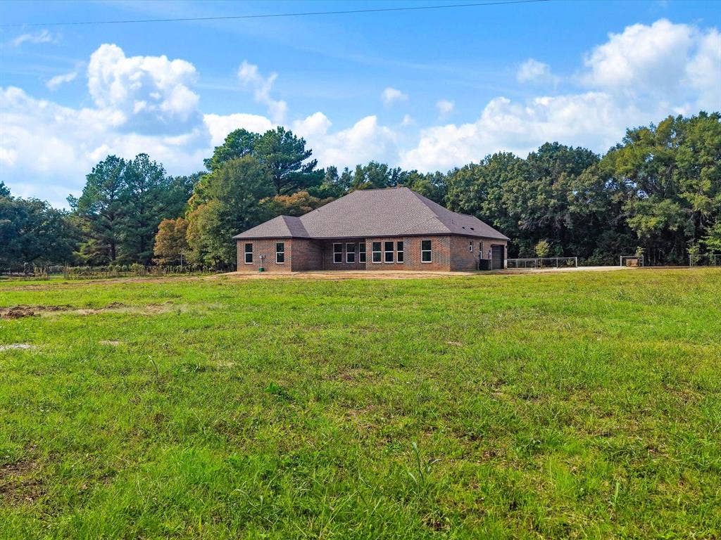 475 Loren Boyd Road, Combine, TX 75159 Single-story brick exterior featuring a multi-gabled roofline and expansive surrounding acreage