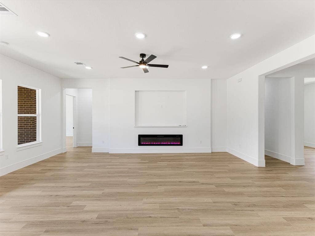 475 Loren Boyd Road, Combine, TX 75159 Interior featuring wood-finish flooring, recessed lighting, a ceiling fan, a built-in electric fireplace, and a recessed wall niche