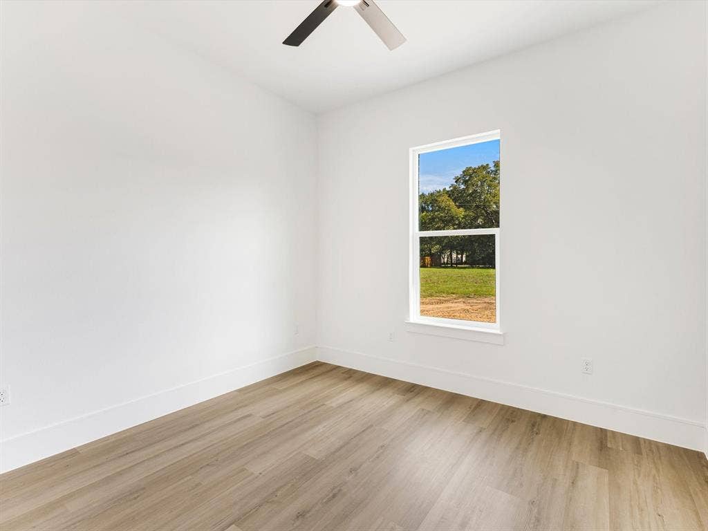 475 Loren Boyd Road, Combine, TX 75159 Neutral interior space featuring wood-finish flooring, a ceiling fan, and a single-hung window
