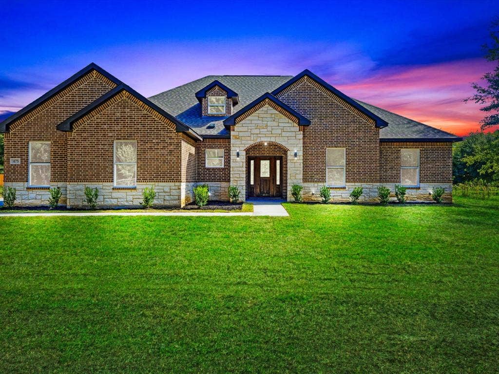 475 Loren Boyd Road, Combine, TX 75159 Brick and stone facade featuring a gabled roofline, arched entryway, and multi-pane front door