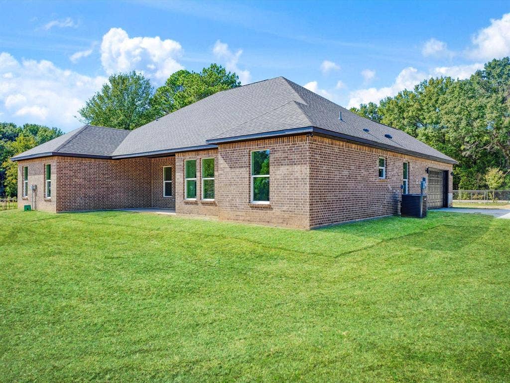 475 Loren Boyd Road, Combine, TX 75159 Brick exterior, hipped roofline, and expansive manicured lawn