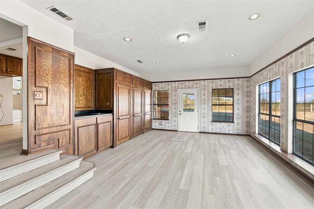 830 Truman Circle, Lancaster, TX 75146 Bar area, cabinets, door to covered patio, and windows to the backyard