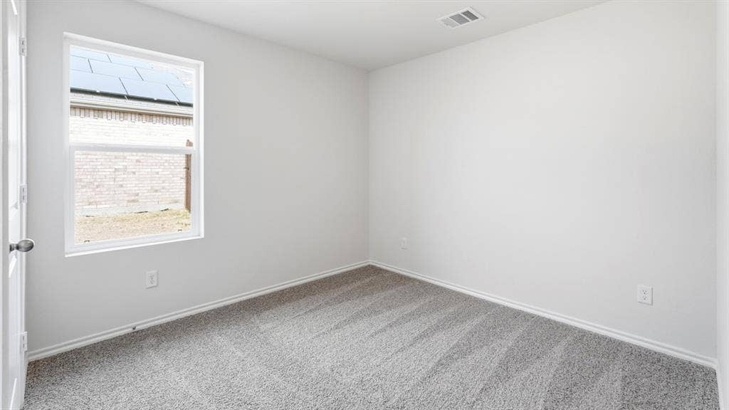 White painted walls and gray carpet flooring