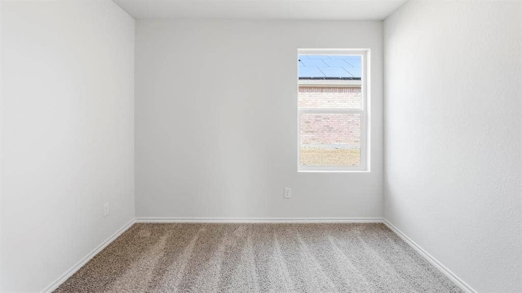 White walls, light gray carpet, and a single window with white trim