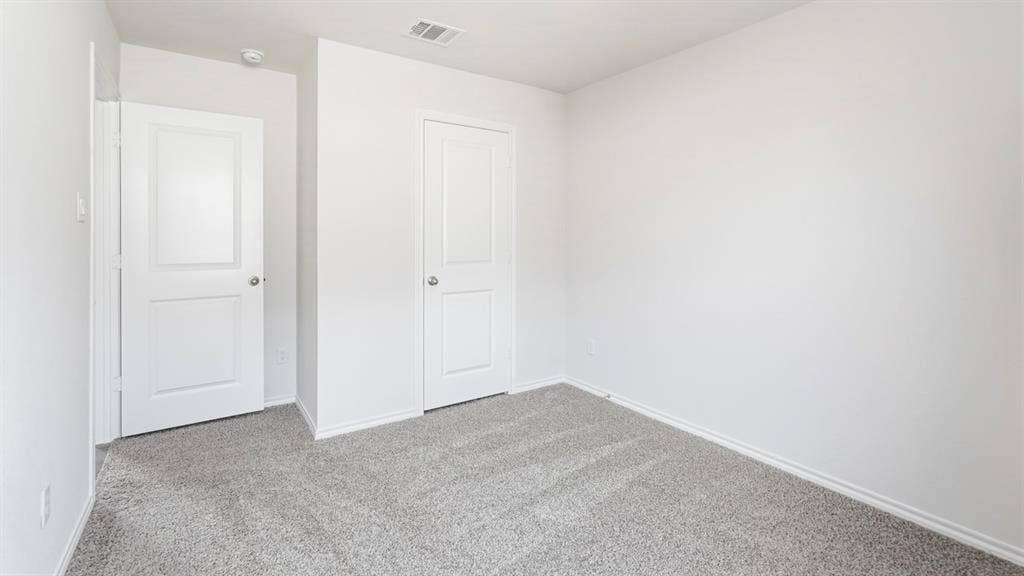 Neutral wall finishes paired with plush gray carpeting