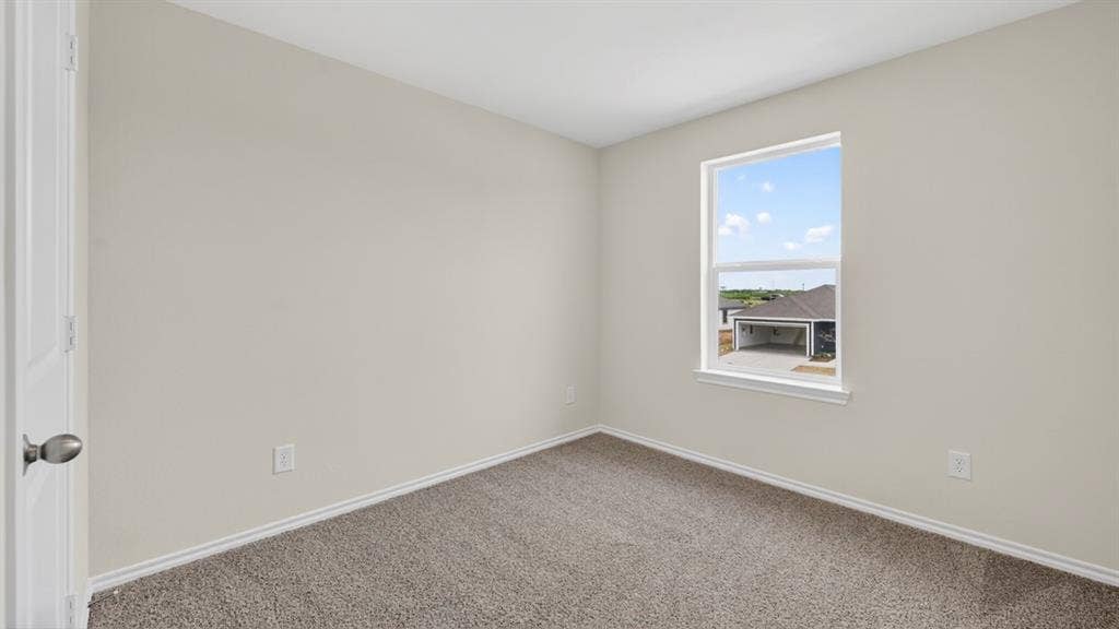 Neutral-toned room featuring a single window, light gray walls, and carpet flooring
