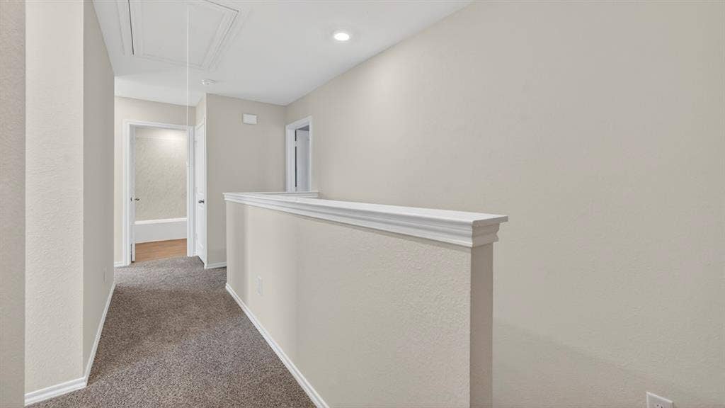 Neutral-toned interior hall with plush gray carpeting
