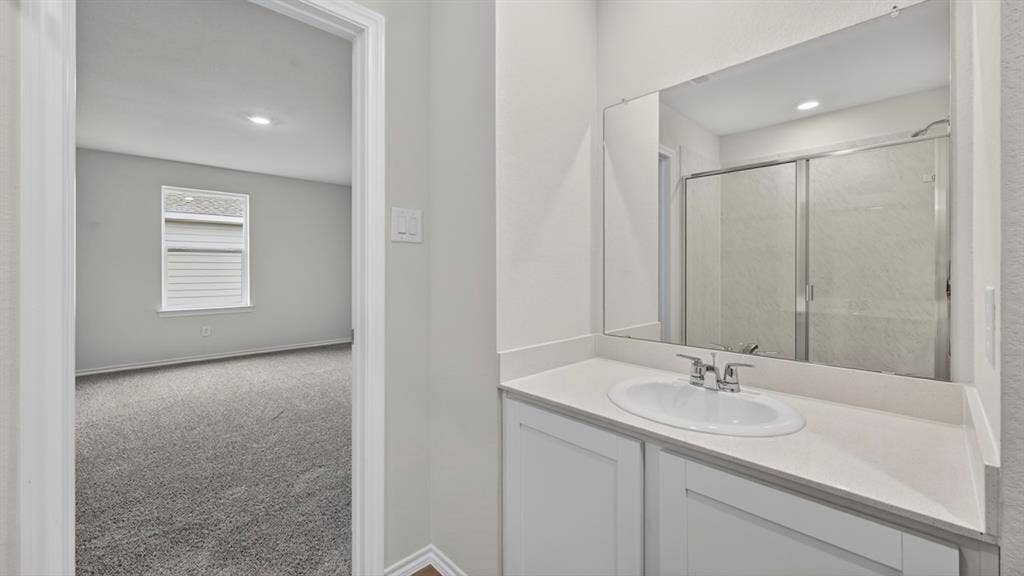 Contemporary bathroom vanity with an integrated sink, polished chrome faucet, and expansive wall-mounted mirror