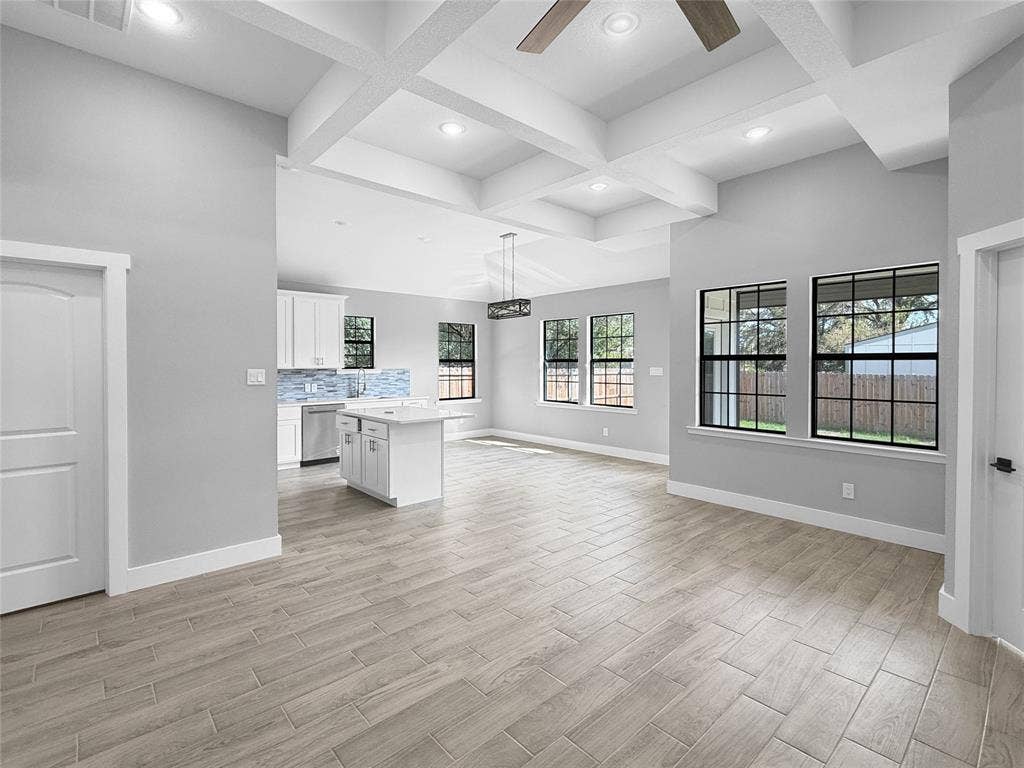 3025 Red Oak Drive, Granbury, TX 76048 Coffered ceiling with recessed lighting, wood-finish tile flooring, and windows with black frames