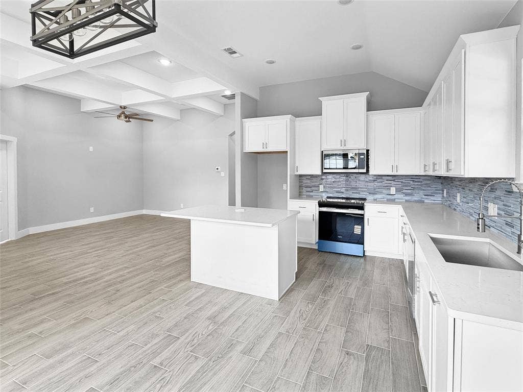 3025 Red Oak Drive, Granbury, TX 76048 Kitchen featuring white cabinetry, quartz countertops, a tiled backsplash, wood-finish flooring, and a coffered ceiling with a geometric pendant light