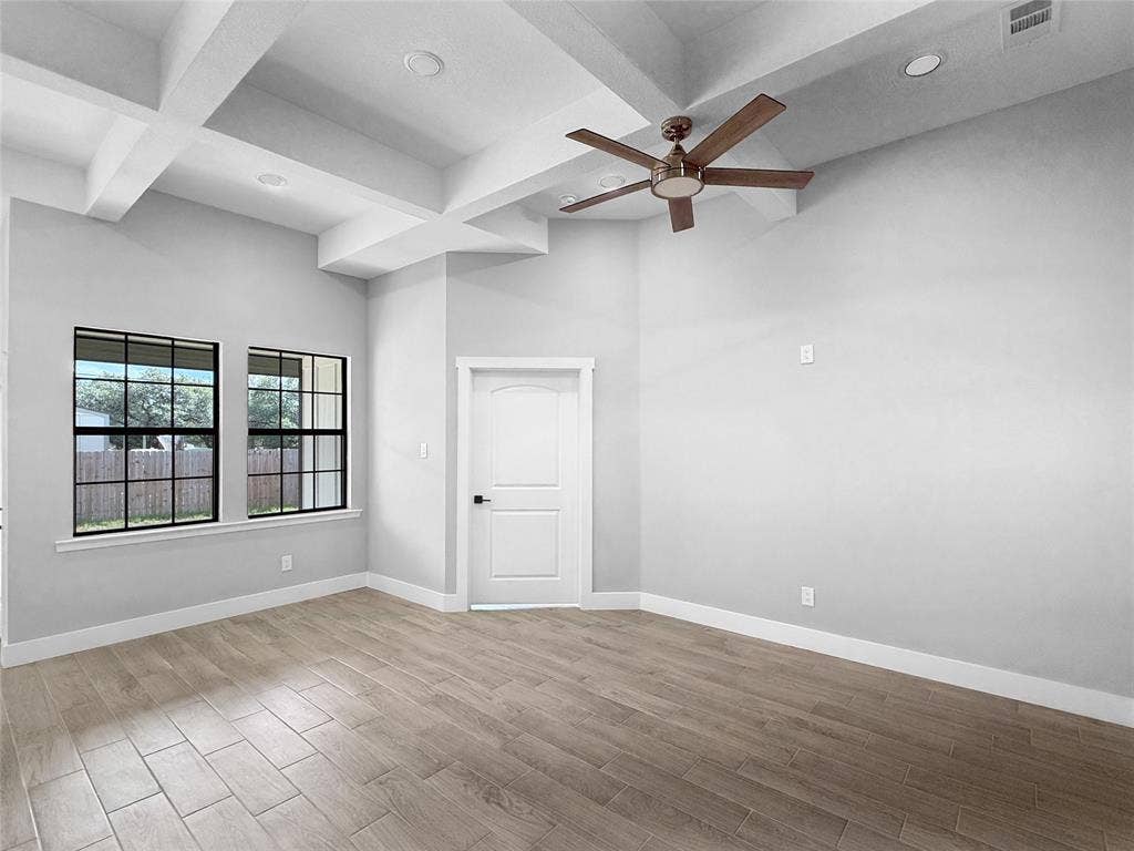 3025 Red Oak Drive, Granbury, TX 76048 Coffered ceilings featuring recessed lighting, wood-finish flooring, and black-framed windows