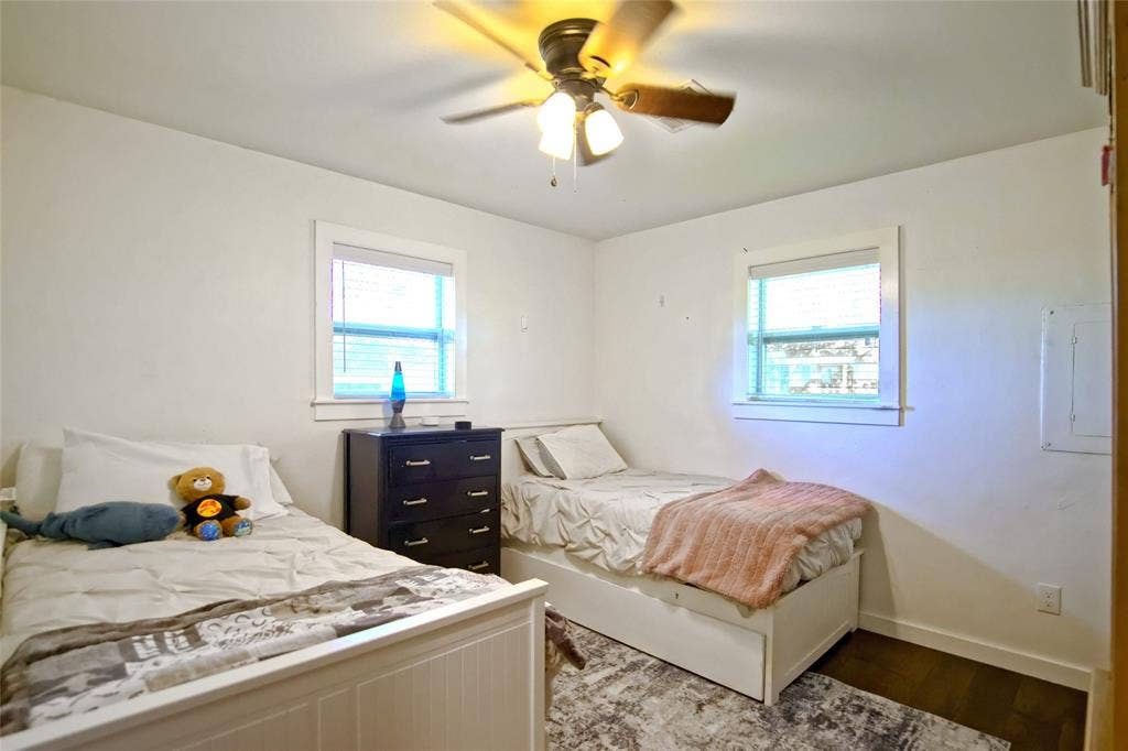 325 & 321 Grassy Way, Elm Mott, TX 76640 Neutral interior featuring two multi-pane windows with trim, hard-surface flooring, and a ceiling-mounted light fixture with a three-blade fan
