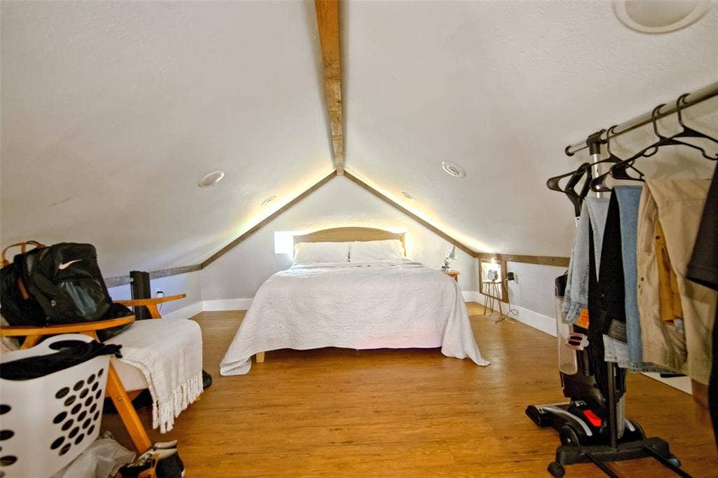 325 & 321 Grassy Way, Elm Mott, TX 76640 Vaulted ceiling featuring exposed wood beam accents and recessed lighting, finished with wood-finish flooring