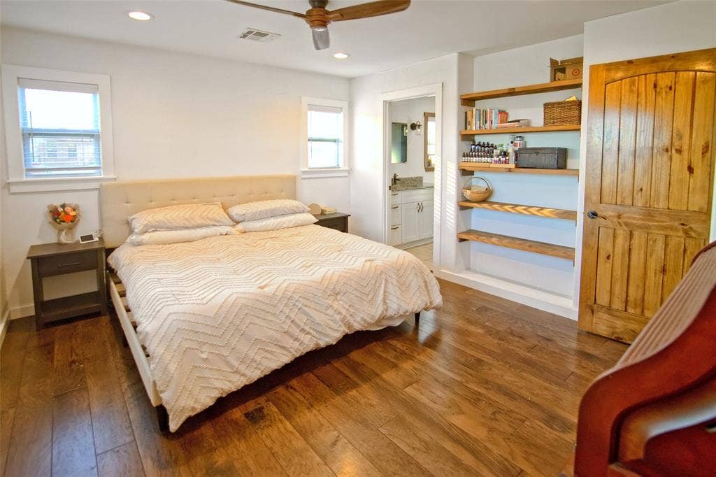 325 & 321 Grassy Way, Elm Mott, TX 76640 Wood-finish flooring, built-in recessed wood shelving, arched wood door, and recessed lighting