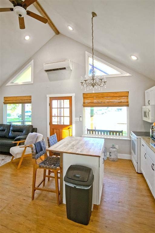 325 & 321 Grassy Way, Elm Mott, TX 76640 Vaulted ceiling featuring exposed wood-finish beams, recessed lighting, a chandelier, wood-finish flooring, and a wall-mounted climate control unit