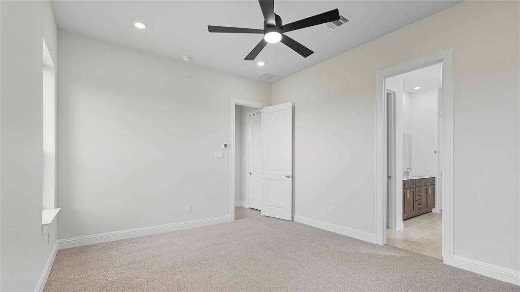 Neutral wall color, carpeted flooring, multi-blade ceiling fan, and recessed lighting