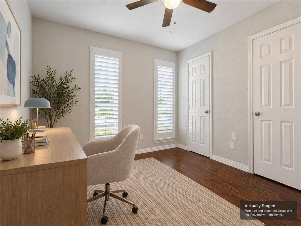 900 Lexington Drive, Plano, TX 75075 Room featuring wood-finish flooring, two windows with plantation shutters, a six-panel door, and a ceiling fan with integrated lighting