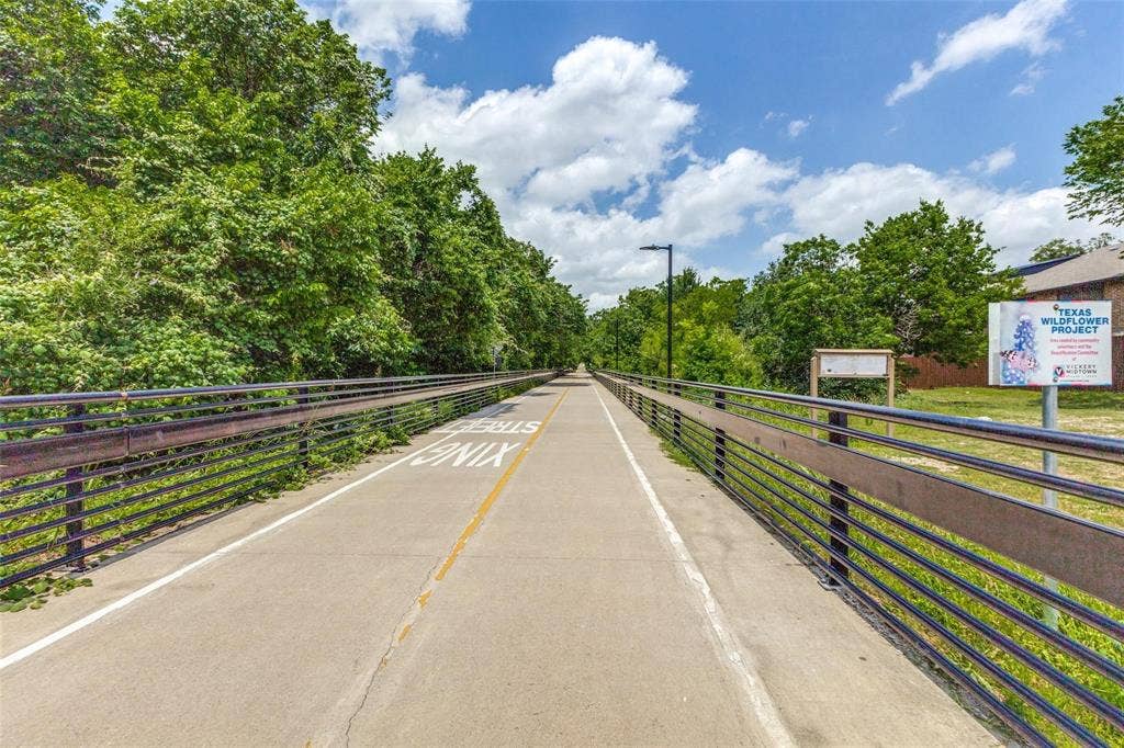 7525 Holly Hill Drive, #20, Dallas, TX 75231 Paved multi-use trail featuring metal guardrails and mature tree canopy