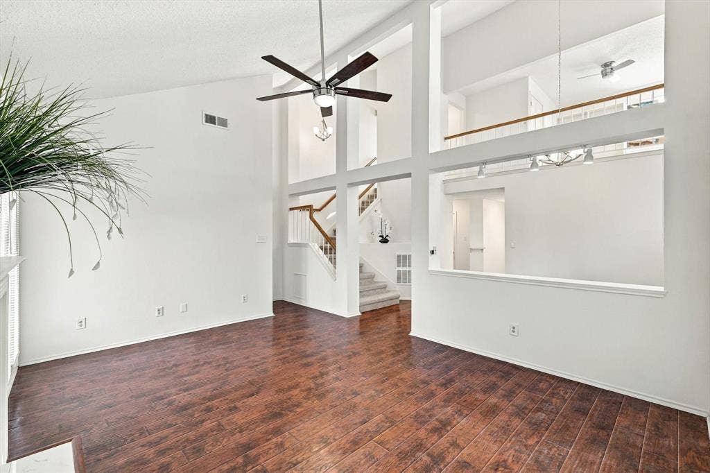 6821 Douglas Creek, Plano, TX 75023 Vaulted ceilings, wood-finish flooring, recessed architectural cutouts, multi-level design, and central ceiling fan