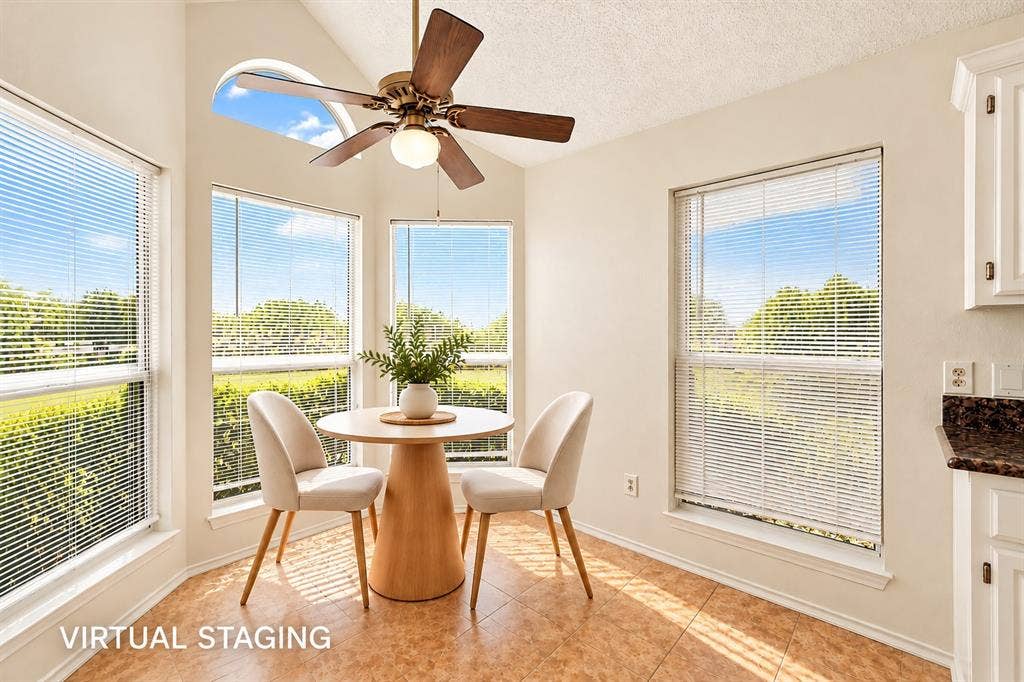 6821 Douglas Creek, Plano, TX 75023 Vaulted ceiling with a centrally mounted ceiling fan, multiple large windows, arched transom window, and tile flooring