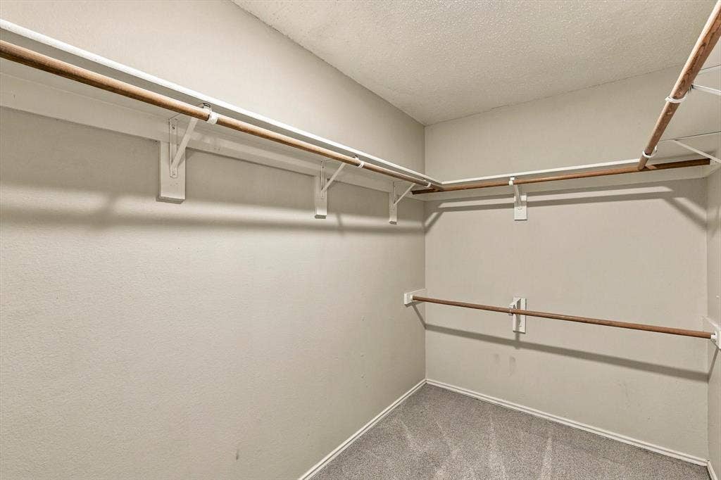 6821 Douglas Creek, Plano, TX 75023 Walk-in storage space featuring multi-level hanging rods and integrated upper shelving