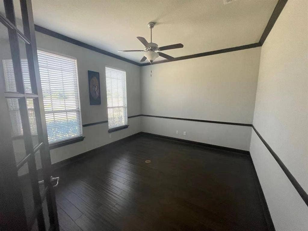 15112 Morning Star Lane, Frisco, TX 75035 Room featuring wood-finish flooring, dark-toned crown and chair rail molding, dual-pane windows, and a ceiling fan with integrated lighting