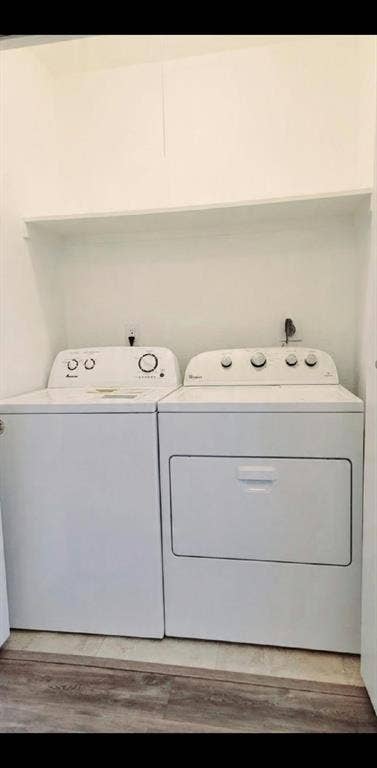 Dedicated laundry closet featuring a built-in overhead storage shelf, tile flooring, and standard washer and dryer hookups