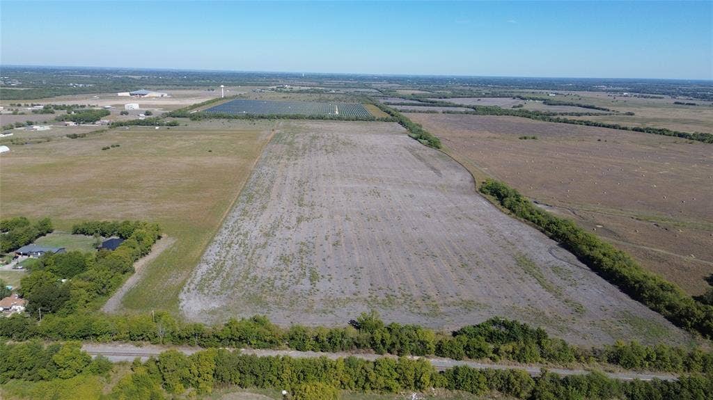 Expansive acreage featuring level topography, cleared open terrain, and mature perimeter trees