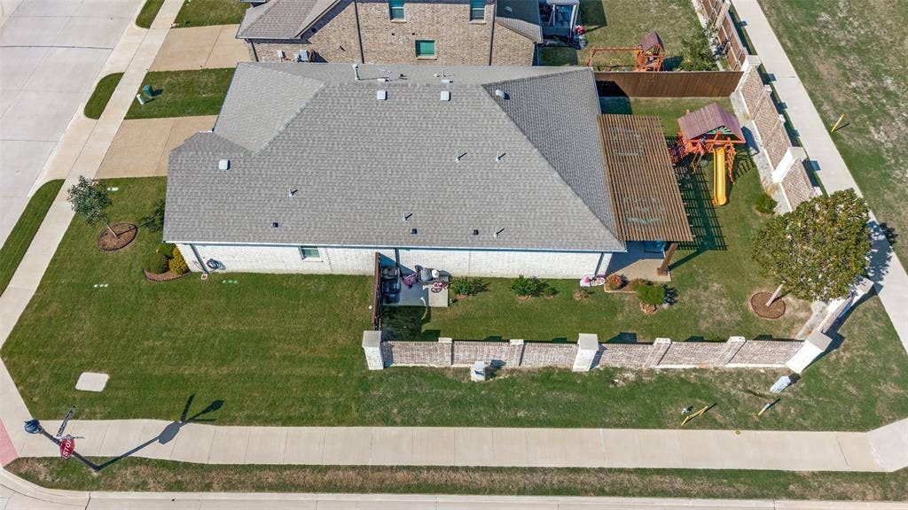 3417 Paintbrush Path, Melissa, TX 75454 Corner lot exterior featuring a masonry fence, a pergola-covered patio, and a side-load garage