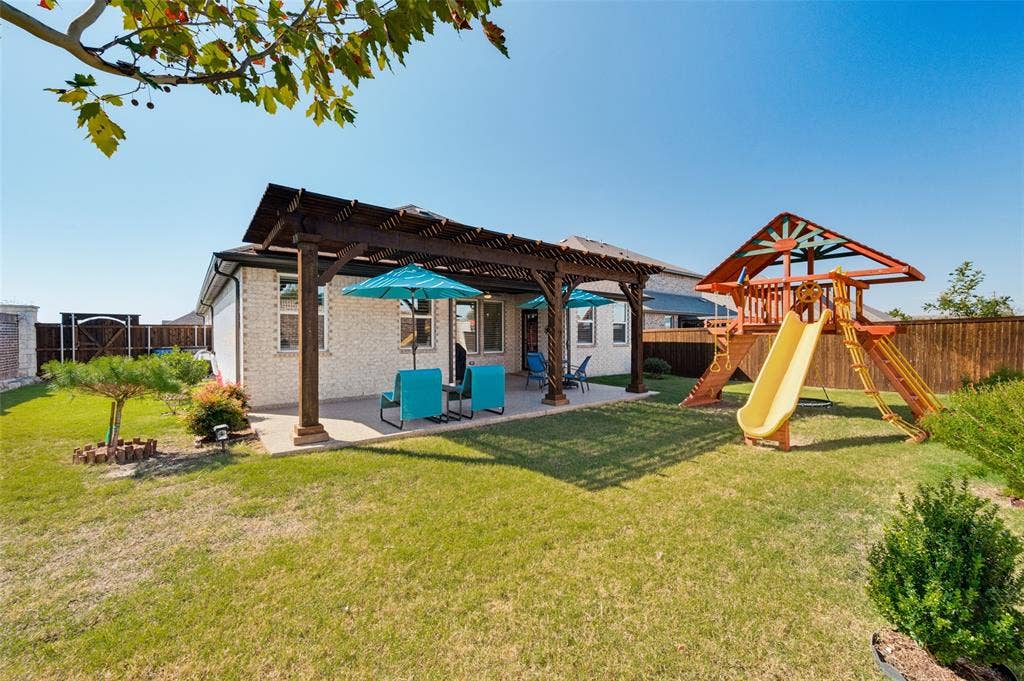 3417 Paintbrush Path, Melissa, TX 75454 Backyard featuring a covered patio with a wooden pergola, concrete surfacing, fenced perimeter, and a grass lawn