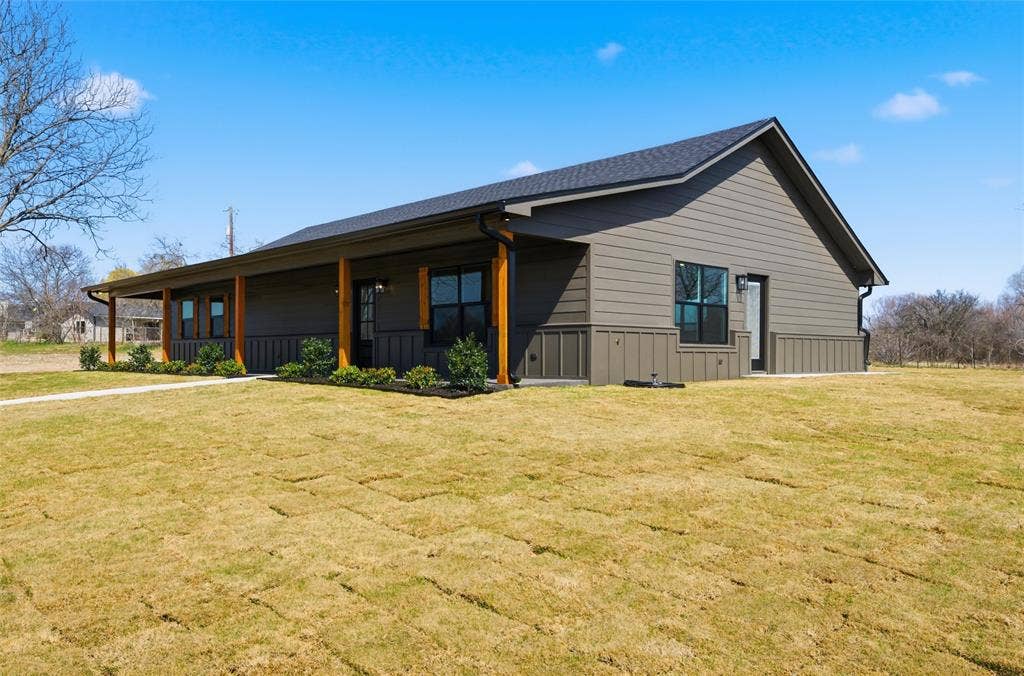 2303 Pilgrim Lane, Lorena, TX 76655 Modern exterior featuring horizontal and vertical siding, a covered porch with timber support beams, and black-framed windows