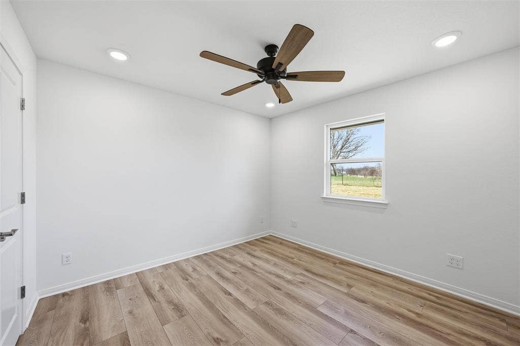 2303 Pilgrim Lane, Lorena, TX 76655 Wood-finish flooring, recessed lighting, and a ceiling fan with wood-toned blades under a single-hung window