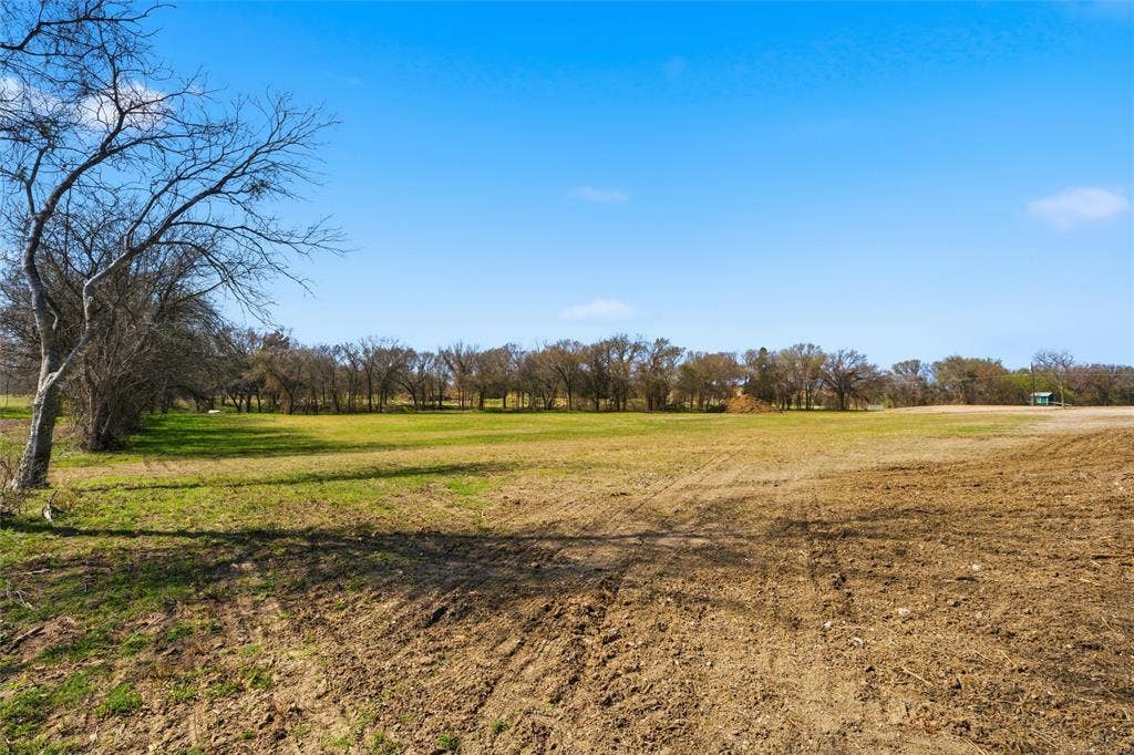 2303 Pilgrim Lane, Lorena, TX 76655 Expansive acreage featuring cleared land, mature tree lines, and open pasture