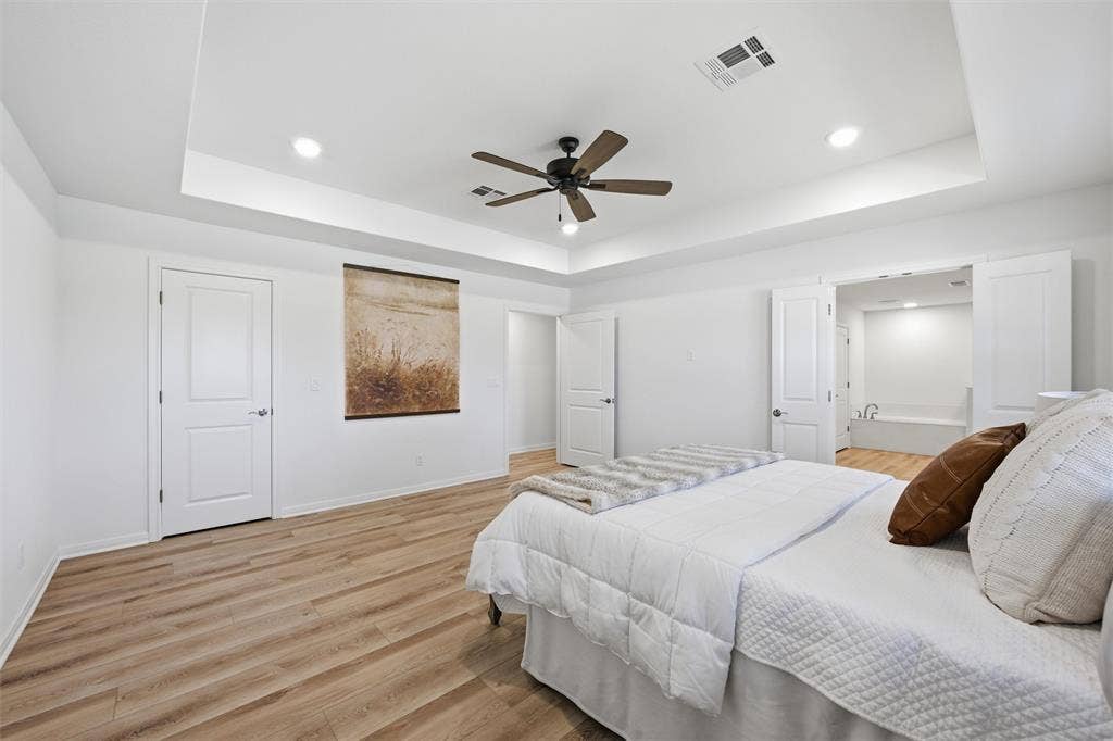 2303 Pilgrim Lane, Lorena, TX 76655 Tray ceiling featuring recessed lighting, wood-finish flooring, and a multi-blade ceiling fan