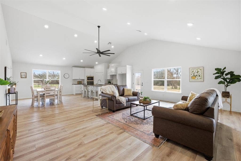 2303 Pilgrim Lane, Lorena, TX 76655 Vaulted ceilings, wood-finish flooring, recessed lighting, central ceiling fan, and white cabinetry featuring a kitchen island
