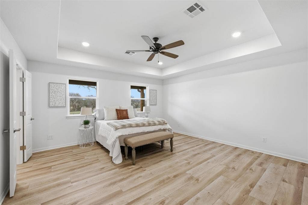 2303 Pilgrim Lane, Lorena, TX 76655 Tray ceiling with recessed lighting, wood-finish flooring, and integrated ceiling fan