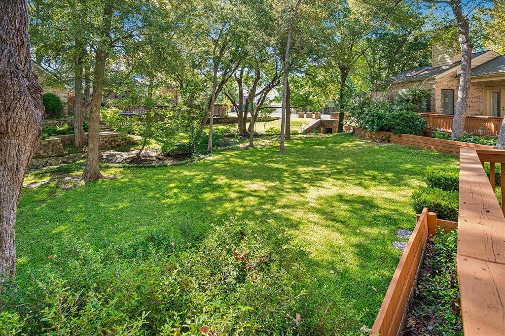 2926 N Saint Andrews Drive, Richardson, TX 75082 Yet another view of the large grassed backyard showing the creek running the length of the yard.