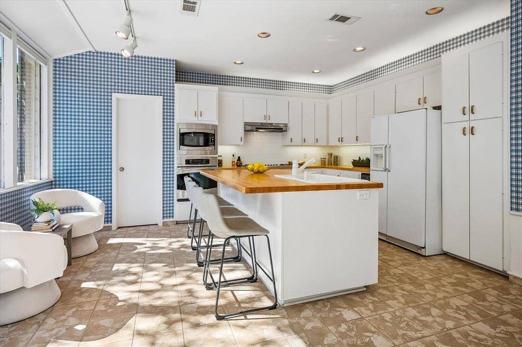 2926 N Saint Andrews Drive, Richardson, TX 75082 The kitchen has newly refinished butcher block wood countertops and a large island with a sink. The breakfast area can either be used as a siting area as shown or can provide additional eating space with a table and chairs.