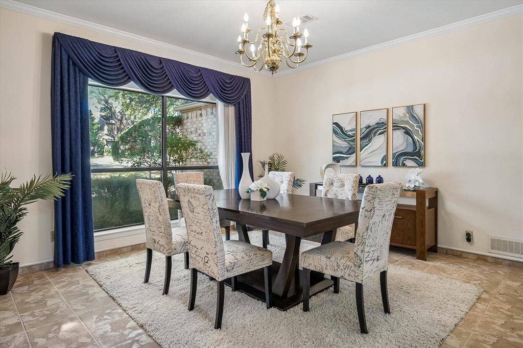 2926 N Saint Andrews Drive, Richardson, TX 75082 Large dining area with a chandelier and large windows which you can see views of the golf course across the street.