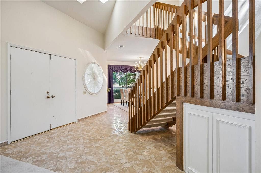 2926 N Saint Andrews Drive, Richardson, TX 75082 Front entry way welcomes you with imported polished tile from Italy showcasing the uniquely designed wooden staircase. Upon entry into the home you are met with high ceiling providing a spacious feeling.