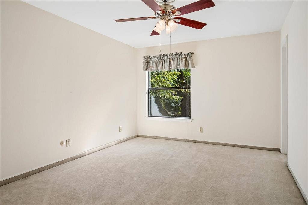 2926 N Saint Andrews Drive, Richardson, TX 75082 Bedroom #3 upstairs has views of the backyard creek lot thru the window and a nice size closet and a ceiling fan.