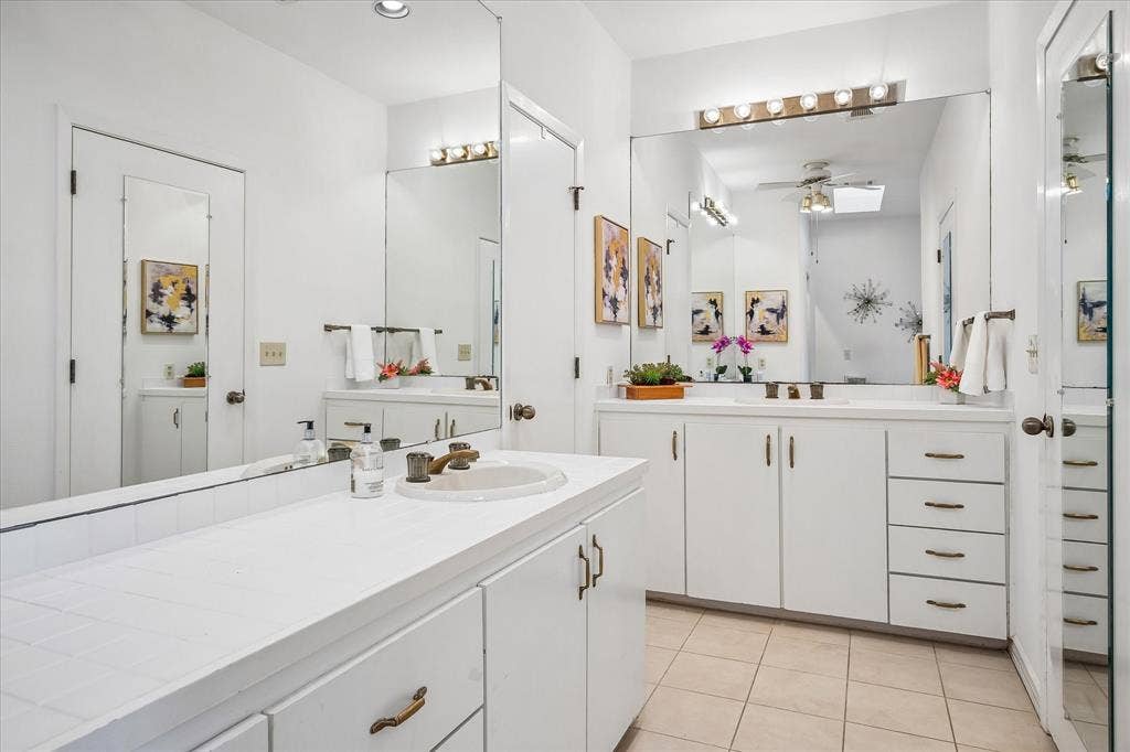 2926 N Saint Andrews Drive, Richardson, TX 75082 Primary bathroom has dual sink vanities with lots of counterspace and plenty of storage.