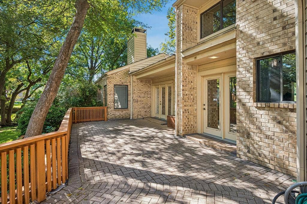 2926 N Saint Andrews Drive, Richardson, TX 75082 A view of the spacious paved deck looking out into the backyard.
